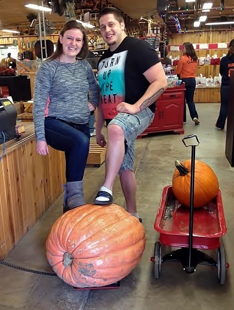 Picture of a couple celebrating their large pumpkin