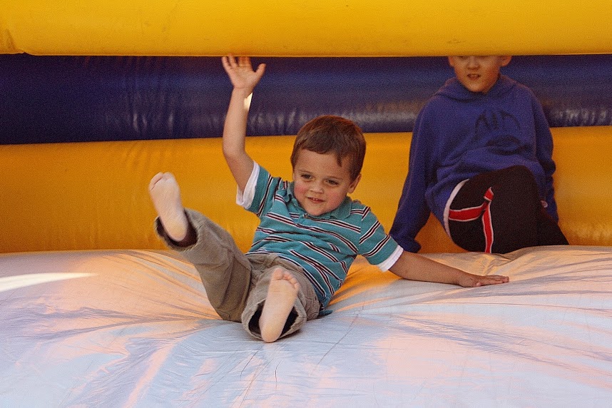 Image of child playing on an inflatable slide.