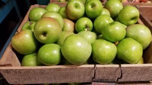 Image of green apples in a crate