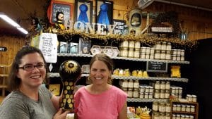Image of Curtis Orchard employee in front of store sold honey.
