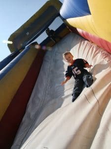 Image of child sliding down slide.